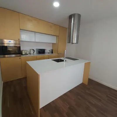 a kitchen with a white counter top in a room at OportoCityView - Ceuta Aliados in Porto
