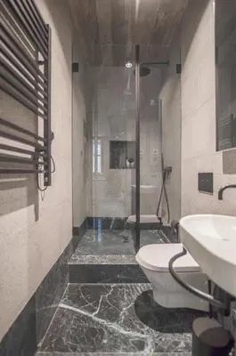 a bathroom with a shower and a toilet and a sink at 62 Design House in Porto