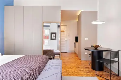 a bedroom with a bed and a table in a room at Blue Moon Studio in Porto