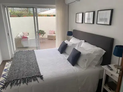 a bedroom with a large white bed with blue pillows at Lapa City Loft in Porto