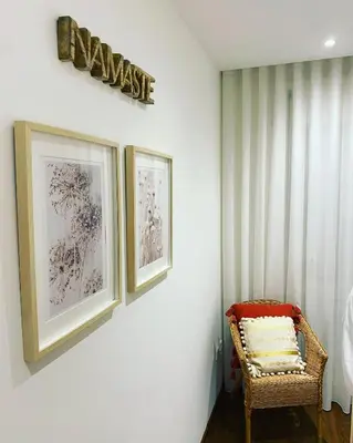a room with two pictures on the wall and a chair at Lapa City Loft in Porto