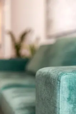 a close up of a couch with plants in the background at Conceição Premium Downtown Apartment by DA'HOME in Porto