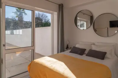a bedroom with a large bed and a mirror at PortoVivo Quental Terrace in Porto