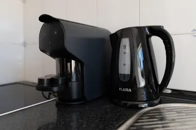 a black coffee maker sitting on a kitchen counter at PortoVivo Quental Terrace in Porto
