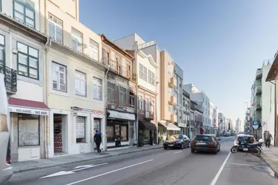 a city street with cars driving down a street with buildings at PortoVivo Quental Terrace in Porto