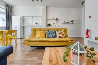 a living room with a yellow couch and a table at Travel & Live Bolhão apartments in Porto