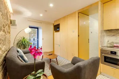 a living room with two couches and a table at Riverside 2 Bedroom Apartment by DA'HOME in Porto