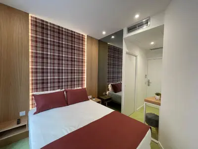 a bathroom with a toilet and a sink and a shower at MyStay Porto São Bento in Porto