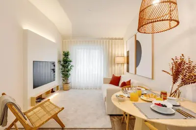a living room with a table and a couch at Virtudes Premium Apartment by DA'HOME in Porto