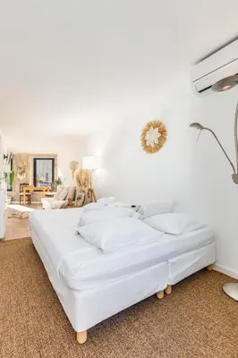 a white bedroom with a large bed with white sheets at Riva House in Porto