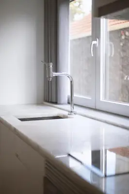 a kitchen counter with a sink and a window at Almada Downtown Apartment by DA'HOME in Porto