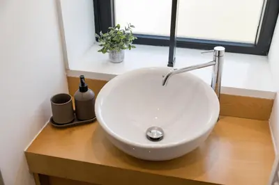a white sink in a bathroom with a window at Alvaro´s Loft Downtown in Porto