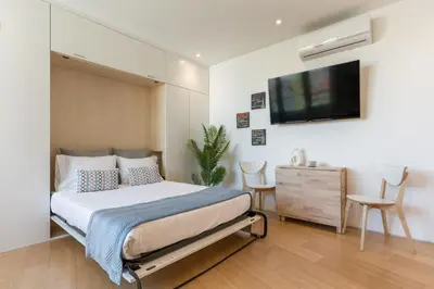 a bedroom with a bed and a tv on a wall at Alvaro´s Loft Downtown in Porto