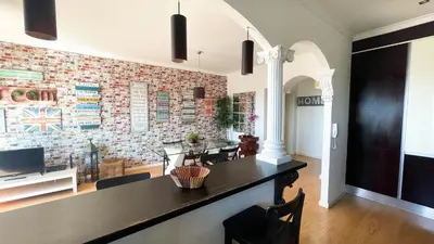 a living room with a tv and a brick wall at HEART OF THE CITY 3 ! in Vila Nova de Gaia