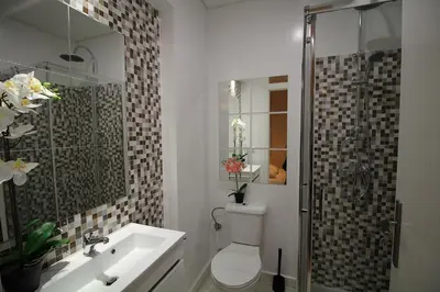 a white bathroom with a toilet and a sink at HEART OF THE CITY 3 ! in Vila Nova de Gaia