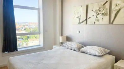 a bedroom with a bed and two paintings on the wall at HEART OF THE CITY 3 ! in Vila Nova de Gaia