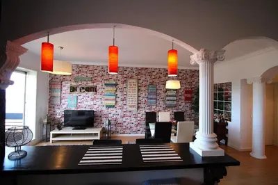 a living room with a table and a brick wall at HEART OF THE CITY 3 ! in Vila Nova de Gaia