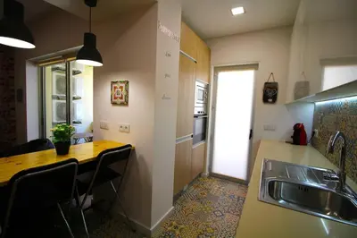 a kitchen with a table and a sink and a counter at HEART OF THE CITY 5 ! in Porto