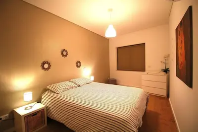 a bedroom with a bed and a flat screen tv at HEART OF THE CITY 5 ! in Porto