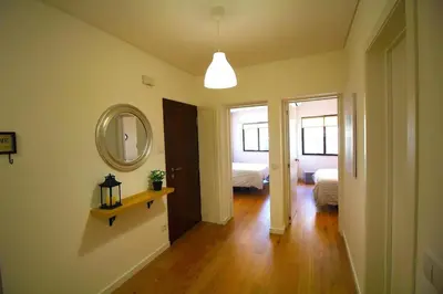 a hallway with a mirror and a room with a bed at HEART OF THE CITY 5 ! in Porto