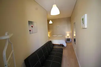 a living room with a couch and a bed at HEART OF THE CITY 7 ! in Vila Nova de Gaia