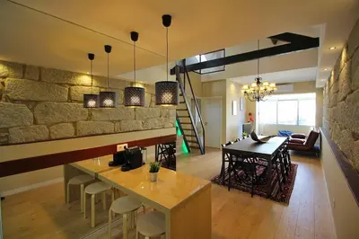 a living room and dining room with a table and chairs at HEART OF THE CITY 7 ! in Vila Nova de Gaia