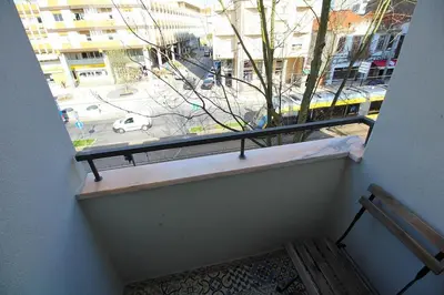 a view of a street from a window with a bench at HEART OF THE CITY 7 ! in Vila Nova de Gaia