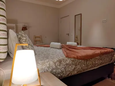 a bedroom with a large bed and a lamp at Salty Swell in Porto