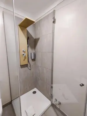 a bathroom with a shower with a glass door at Salty Swell in Porto