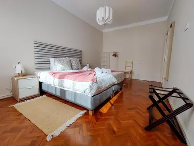 a bedroom with a bed and a wooden floor at Salty Swell in Porto