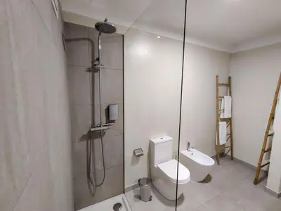 a bathroom with a shower and a toilet at Salty Swell in Porto