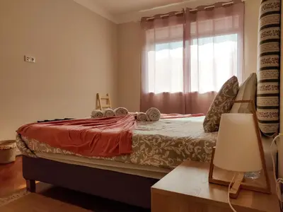 a bedroom with a large bed with a window at Salty Swell in Porto
