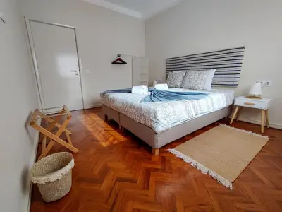 a bedroom with a bed and a wooden floor at Salty Swell in Porto