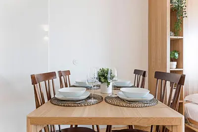 a dining room table with bowls and plates on it at Downtown Studio w/ Gorgeous Views by LovelyStay in Porto