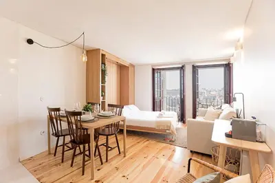 a living room with a table and a couch at Downtown Studio w/ Gorgeous Views by LovelyStay in Porto