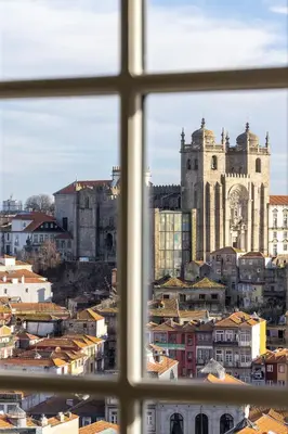 a bedroom with a large bed and a wooden ceiling at Panoramic Historic Views Private Balconies - Apt E in Porto