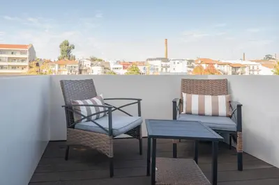 two chairs and a table on a balcony with a view at Liiiving in Porto - Luxury Gallery Apartment II in Porto