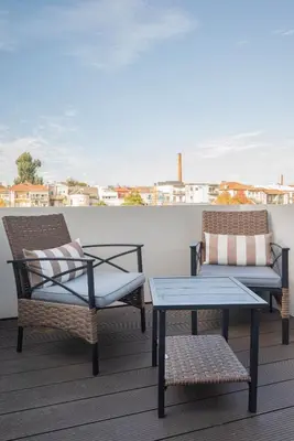 two chairs and a coffee table on a balcony at Liiiving in Porto - Luxury Gallery Apartment II in Porto