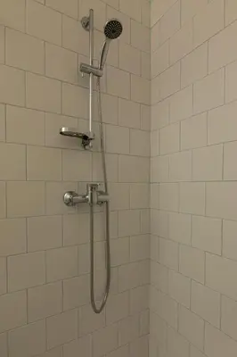 a shower with a shower head in a bathroom at ORM Torrinha Apartment in Porto