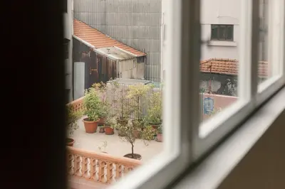 a view from a window of a balcony with potted plants at VIVA Three Magi Residence in Porto