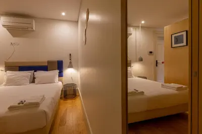 a bedroom with two beds and a mirror at ORM - Almada Balcony Apartment in Porto
