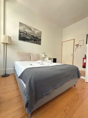 a bedroom with a large bed in a room at Great&Cosy São Bento in Porto