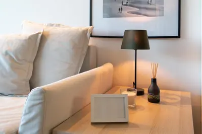 a bedroom with a bed with a table with a lamp at Host Wise - Luxurious Impressive Apartment - Balcony and Pool in Vila Nova de Gaia