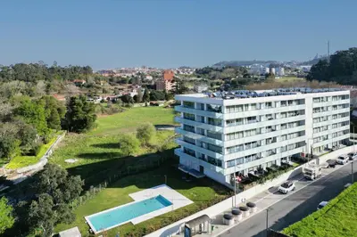 an aerial view of a building with a swimming pool at Host Wise - Luxurious Impressive Apartment - Balcony and Pool in Vila Nova de Gaia