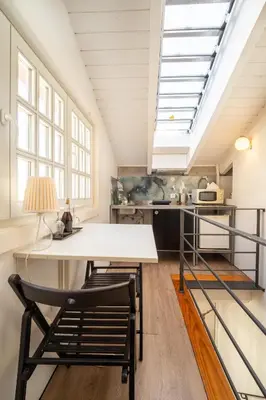 a kitchen with a table and chairs in a room at Casa Dos Caldeireiros in Porto