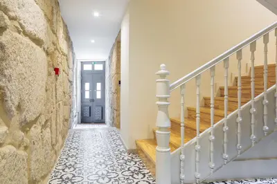 a hallway with stairs and a blue door at ORM Carregal Apartment in Porto