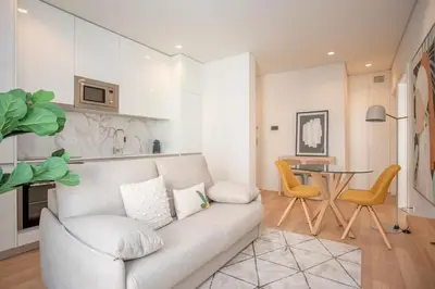 a living room with a couch and a table at Liiiving in Porto - City Design Apartments in Porto