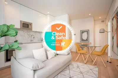 a sign in a living room with a couch and a table at Liiiving in Porto - City Design Apartments in Porto
