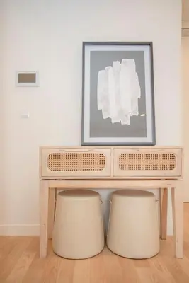 a table with two stools in a room with a picture at Liiiving in Porto - City Design Apartments in Porto