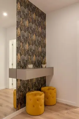 a room with two yellow stools in front of a wall at Host Wise - Bright & Contemporary Flat - Ace Location in Porto